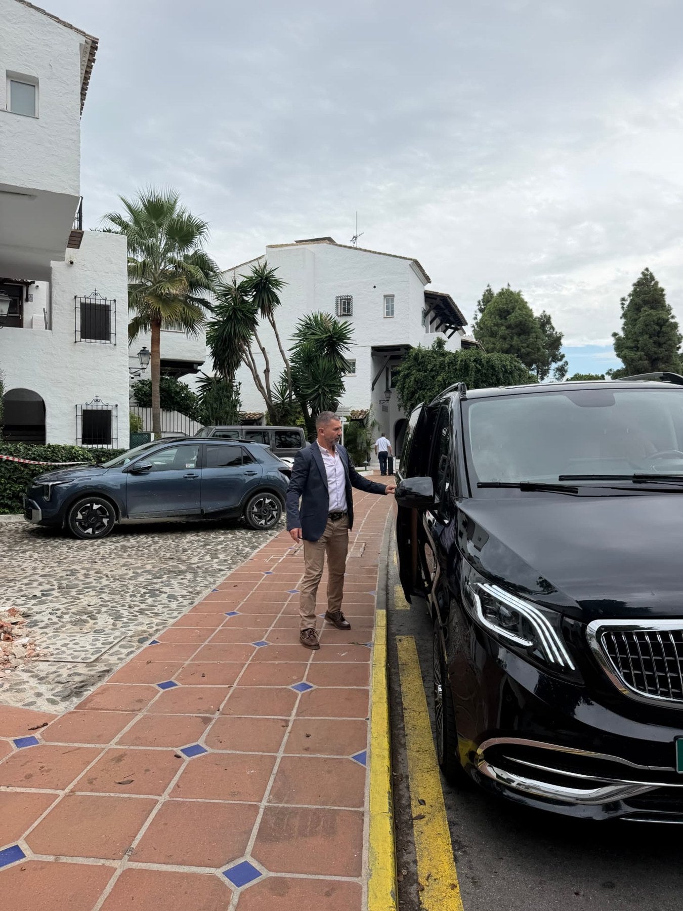 Private chauffeur welcoming guests to the Maybach VIP van
