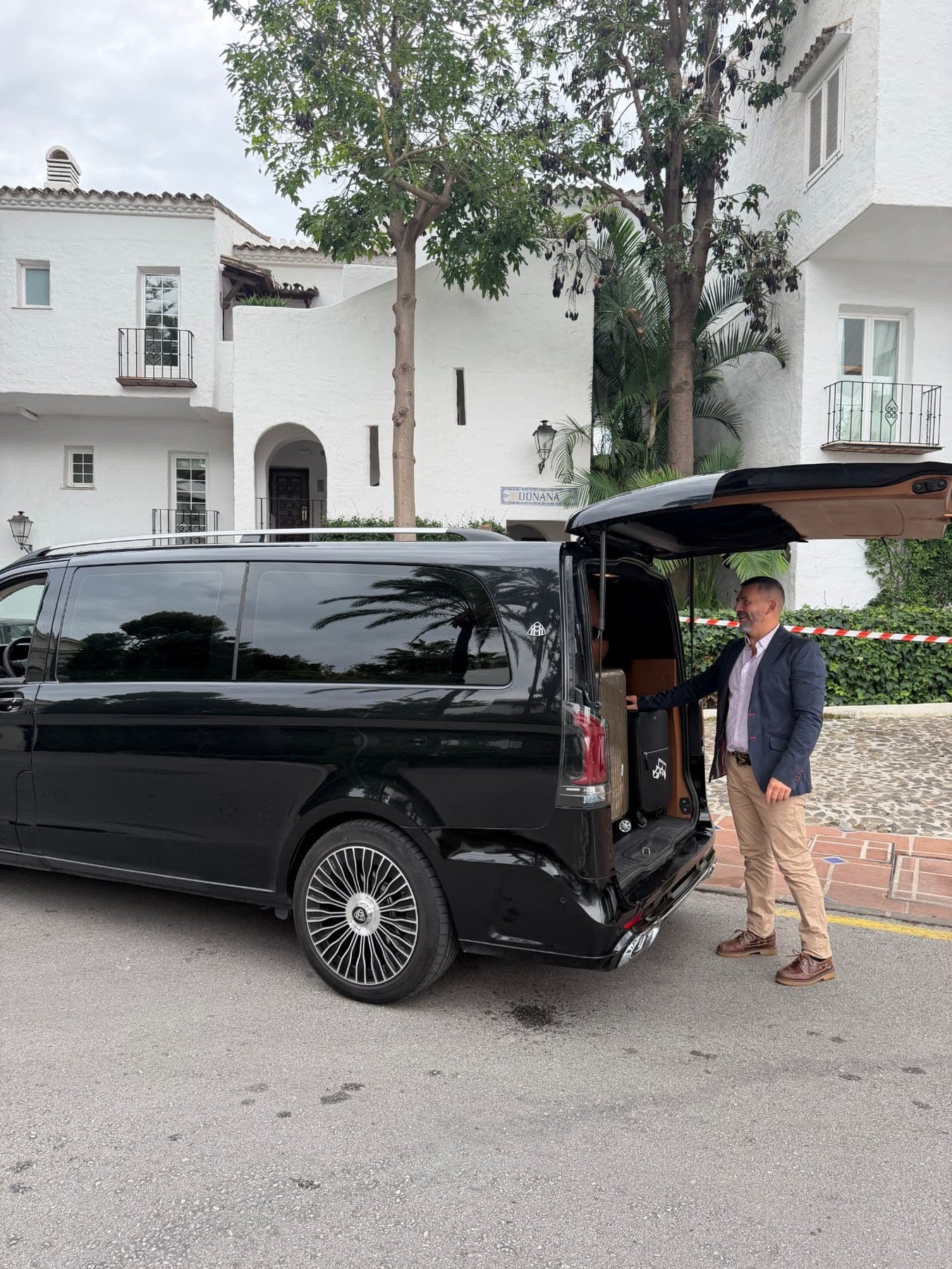 Chauffeur loading luggage into the Maybach VIP van in Marbella